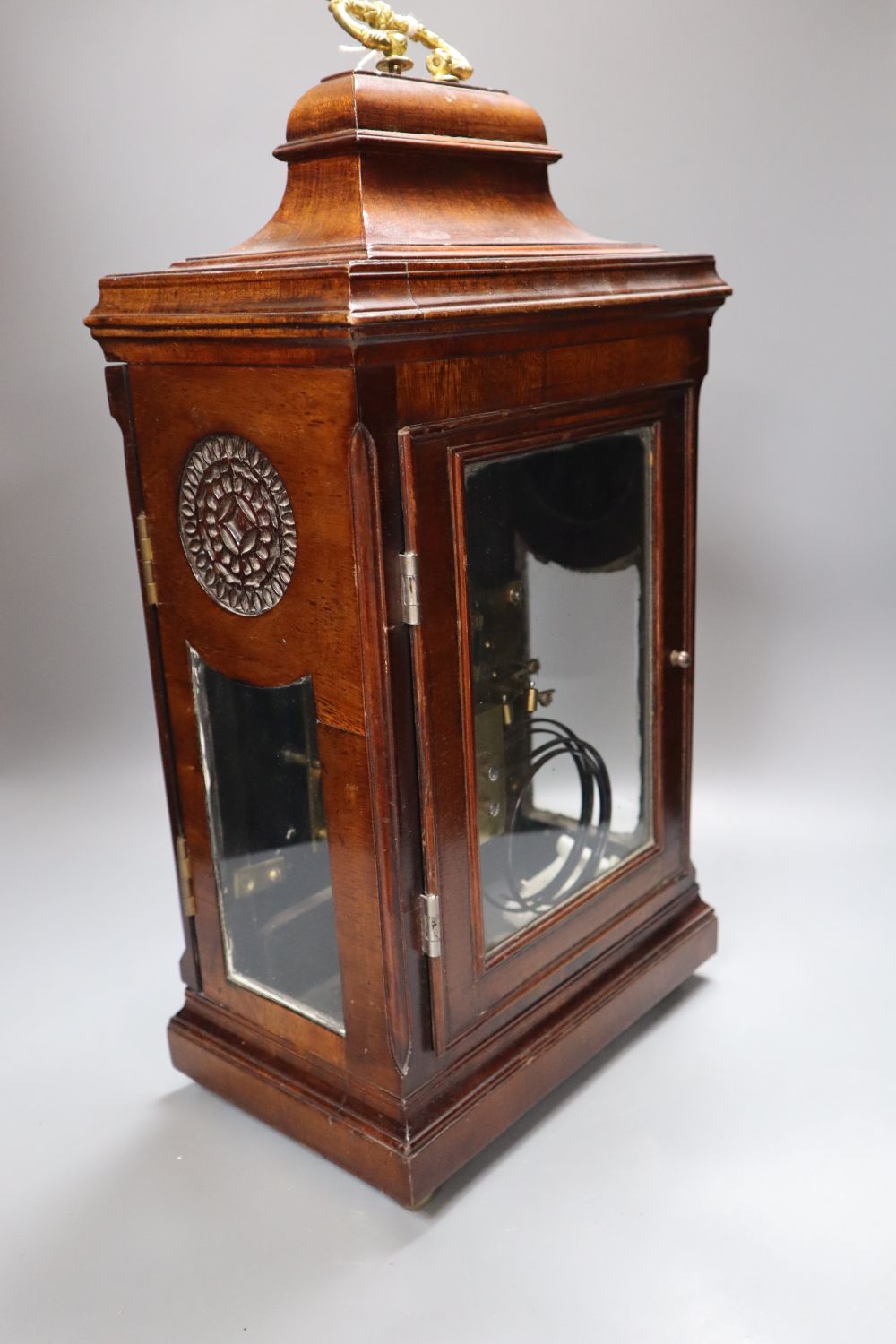 A George III-style mahogany mantel clock, 5.75 inch arched dial, gong striking movement, with key and pendulum, height 49cm